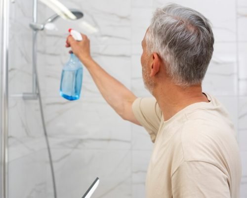 side-view-senior-man-cleaning-shower_23-2149535082